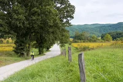 bicyclist riding through Cades Cove in the Smoky Mountains 